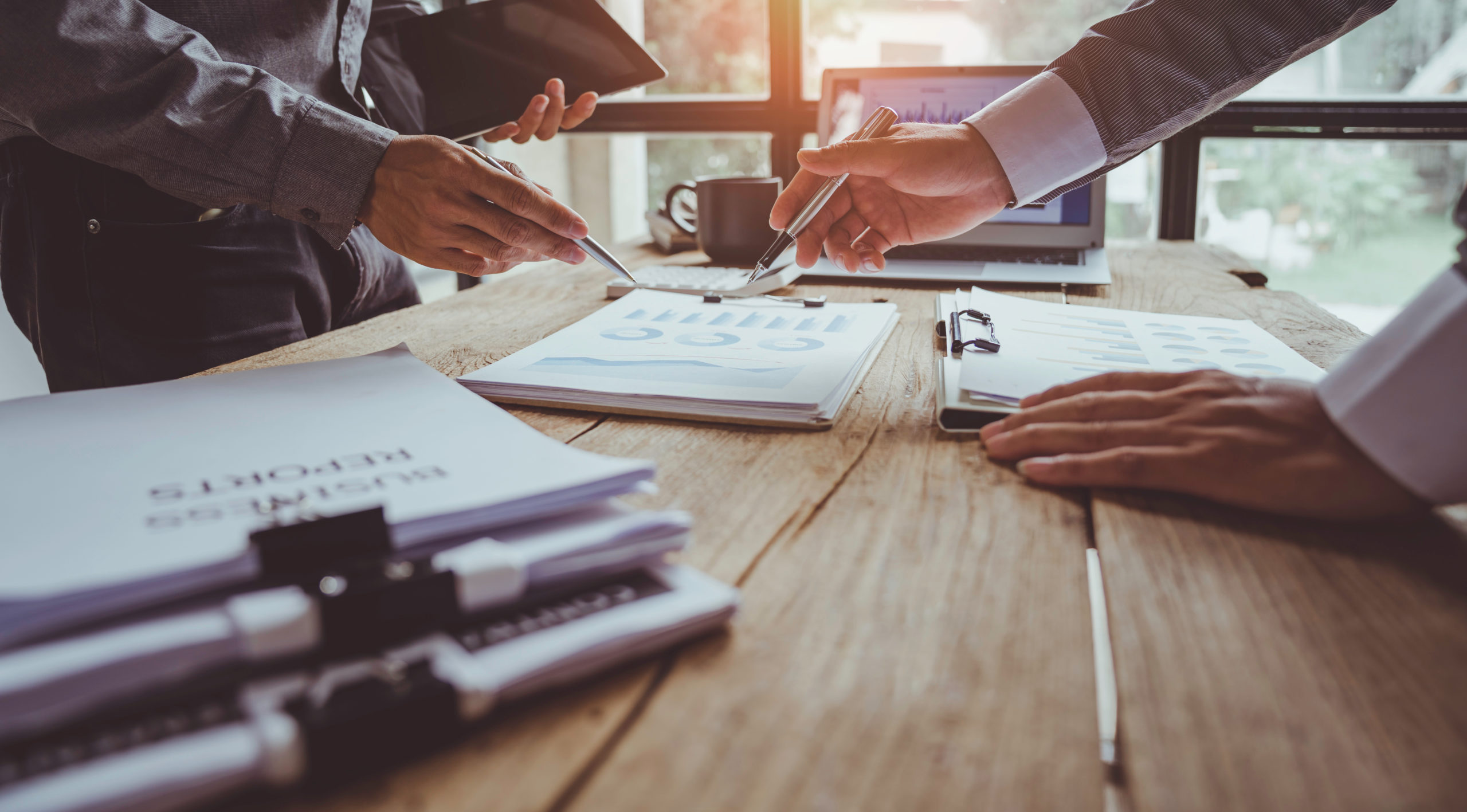 AdobeStock 504829031 MaleHandsPrintedReports scaled 1